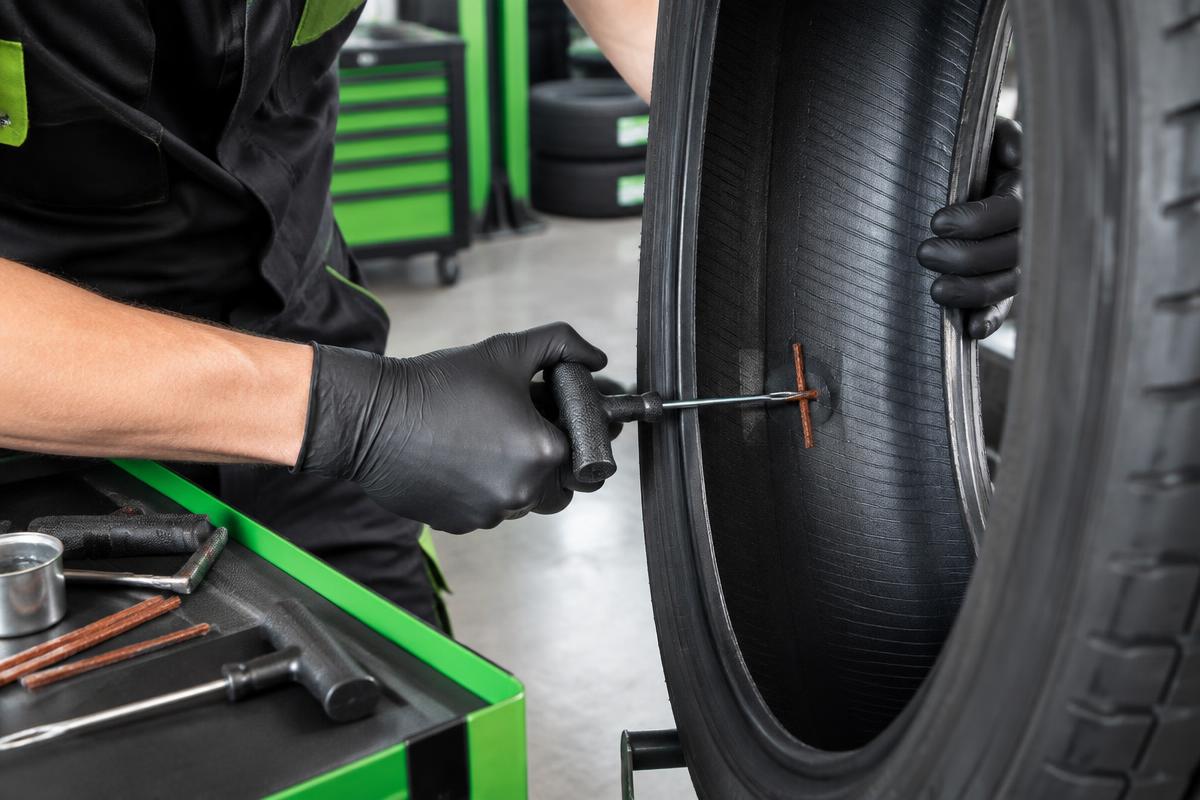 Professional repair being applied inside a tire